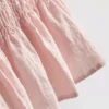 Top bez rękawów z marszczonym dołem w stylu peplum